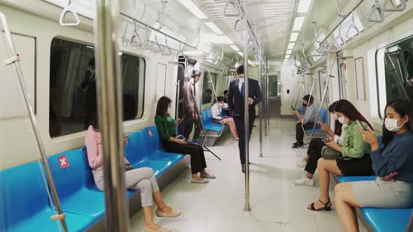 Crowd of People Wearing Face Mask on a Crowded Public Subway Train Travel