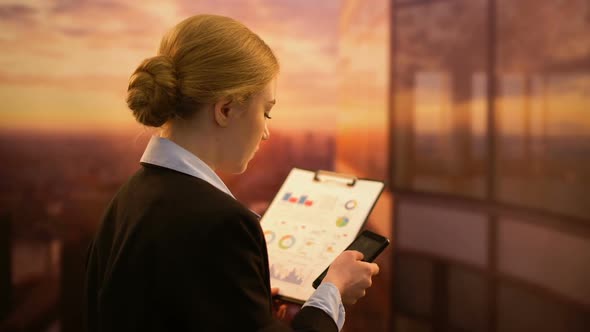 Businesswoman Calling Colleague to Check Financial Report, Company Performance