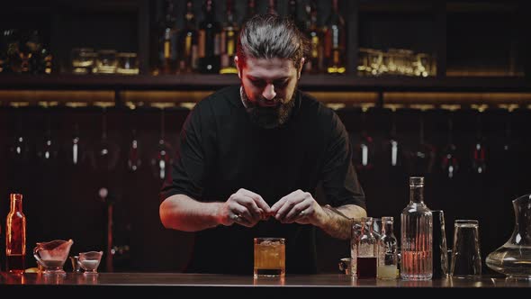 Cool Bartender Decorates Finished Cold Cocktail for Client