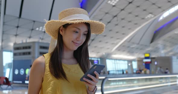 Woman check on cellphone in the airport