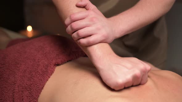 Close-up Professional Back Massage of a Male Masseur Makes a Male Athlete To a Client in an Office