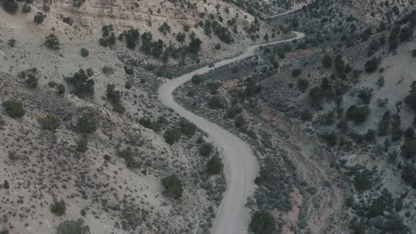 Drone shot of truck driving through desert. Drone shot of truck driving down dirt road. Vehicle driv