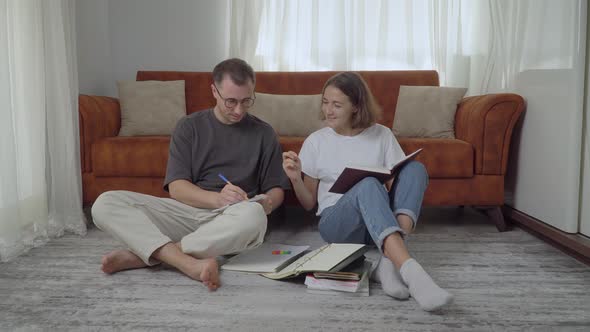 Boy and Girl Students Prepare for the Exam at Home Sitting on the Floor