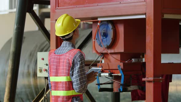 Engineer Working With Tablet In Factory