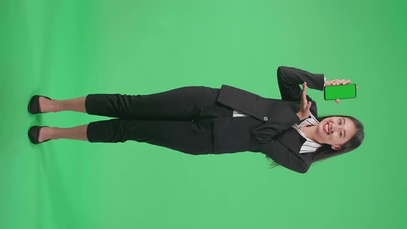 Full Body Of Asian Business Woman With Smile Recommending Green Screen Mobile Phone On Green Screen