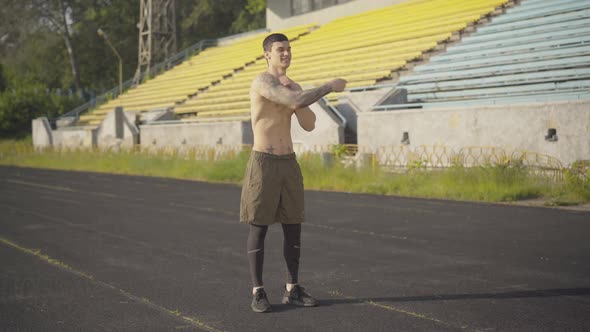 Wide Shot of Cheerful Sportsman Using Jumping Rope for Training Outdoors, Portrait of Happy Young