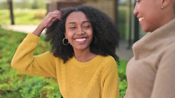 woman wants to high-five to a friend, but the other woman accidentally ignores