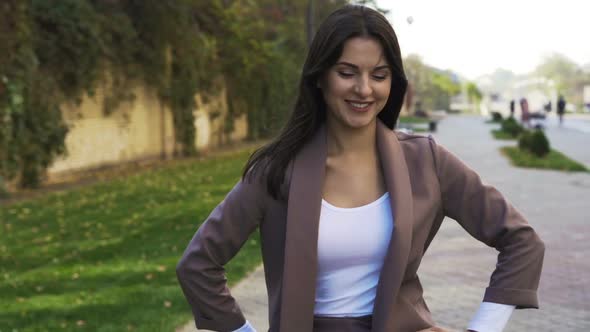 Beautiful Brunette Businesswoman In Business Clothes Walks In The City