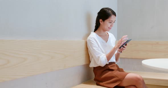 Woman check on cellphone in cafe