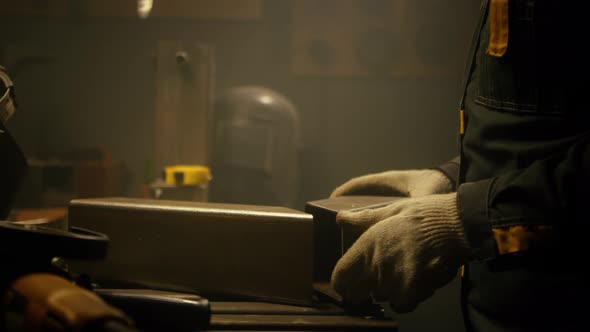 A skilled industrial worker checks a metal part