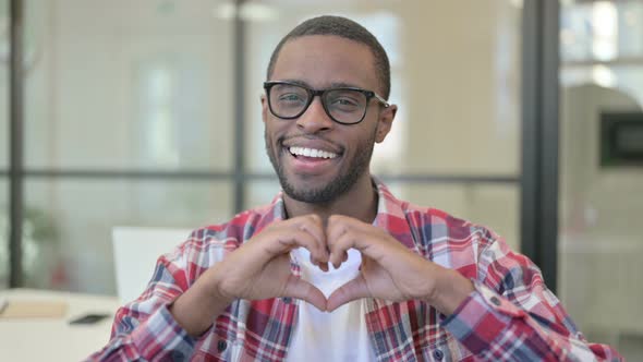 Portrait of African Man Showing Heart Shape By Hands