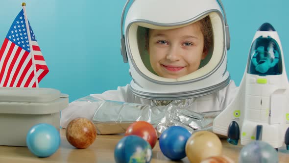 Little Girl 89 Years Old in an Astronaut Costume Smiling Happy Child Looking at the Camera Closeup