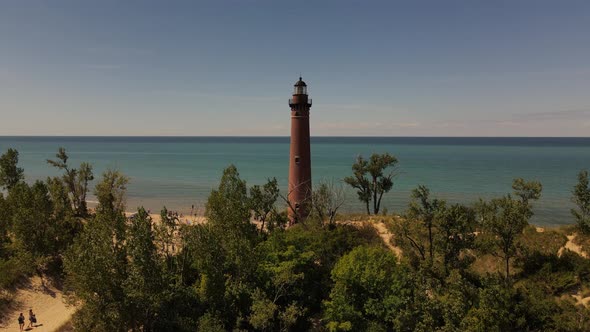 4k drone video of Little Sable Lighthouse in Silver Lake, Michigan in the summer.