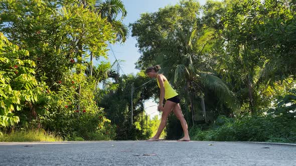 Woman Does Physical Exercises in Tropical Park