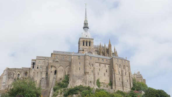 Mont-Saint-Michel island in  front of blue sky  Normandy France 4K 3840X2160 UHD slow tilt  video - 