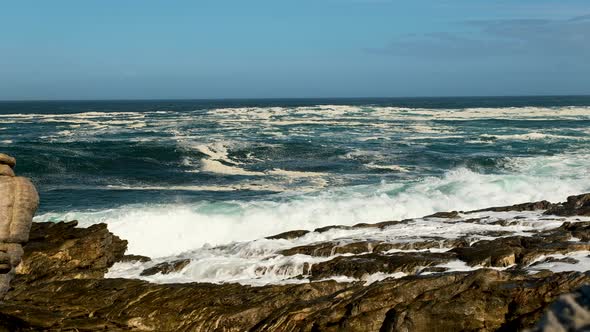 Turbulent Atlantic ocean waves crashing and making a massive splash on rocks