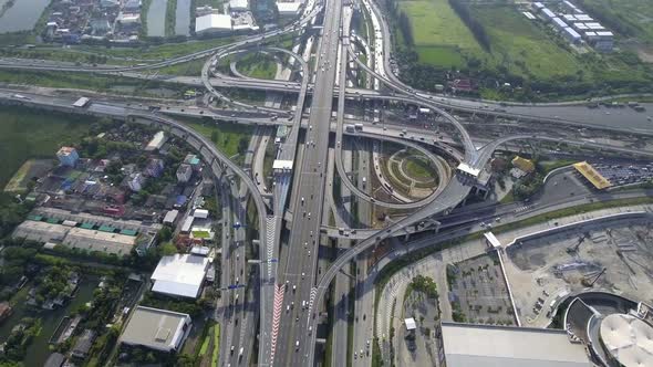 Aerial View of Highway Road Interchange with Busy Urban Traffic Speeding on Road