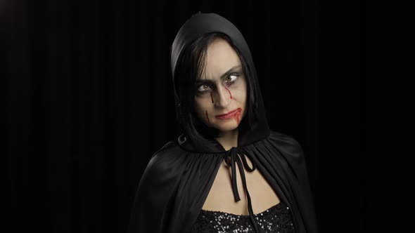 Vampire Halloween Makeup. Woman Portrait with Blood on Her Face.