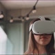 Close up of young woman looking around wearing vr goggles viewed from under - VideoHive Item for Sale