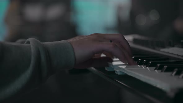 Man's Hand Playing a Piano