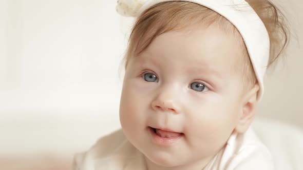 Cute Little Girl Is Looking Into The Camera