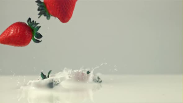 Super Slow Motion Delicious Strawberries Falls Into the Milk with Splashes