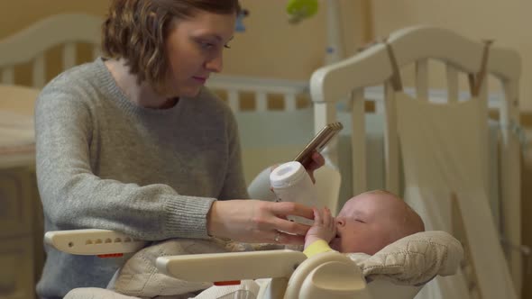 Mother Feeds Baby With Phone