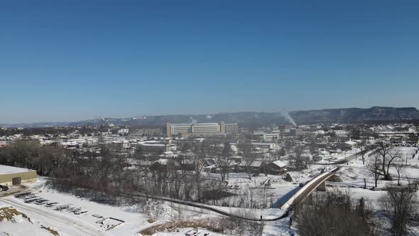 Aerial view of rural neighborhood with large office building and mountains in the background.