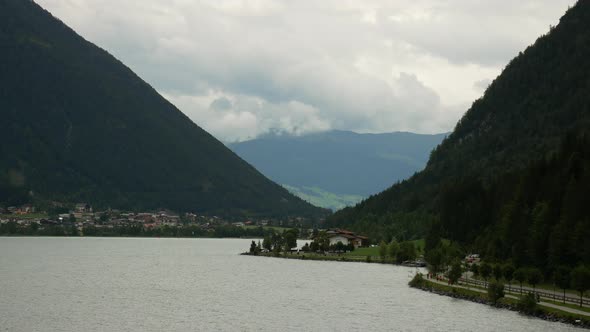 Epic mountain landscape with road,shore and clouds beside beautiful nature lake Achensee in Tyrol,Au