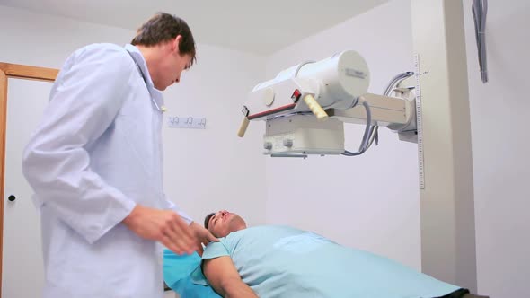 Doctor proceeding a radiography on a patient