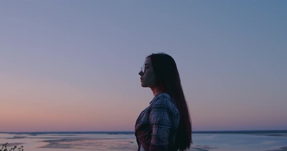 Girl in nature looks thoughtfully into the distance