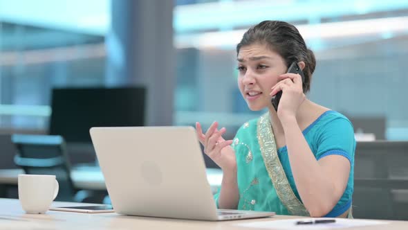 Indian Woman with Laptop Angry on Smartphone