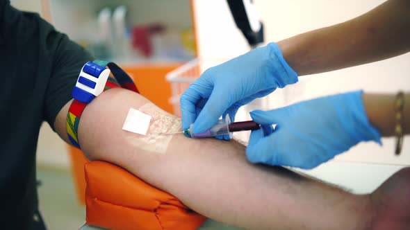 Nurse taking blood sample from vein. 