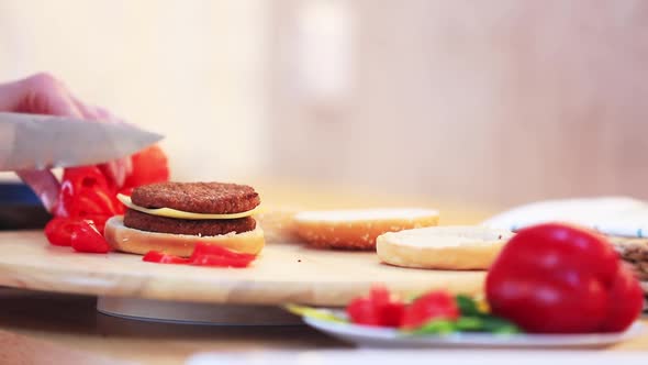 man cut paper for burger on a table at home