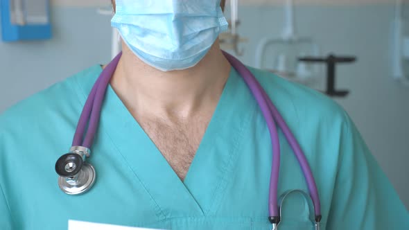 Male Doctor Is Holding a Picture with the Inscription Stay at Home During Coronavirus Epidemic