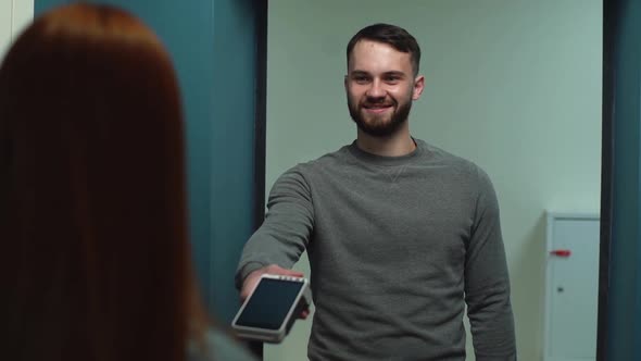 Cheerful Young Delivery Man Giving POS Wireless Terminal To Making Contactless Payment Online Order