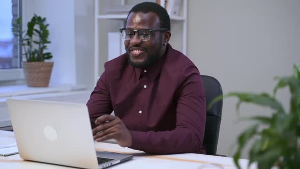 African Man at Virtual Meeting Chatting in Front of Computer Spbas