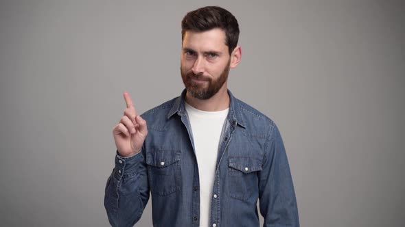 Strict teacher, bossy man with beard wearing sweatshirt standing with admonishing gesture