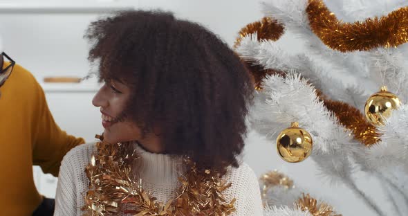 Close Up Afro American Couple in Love Gathered at Home Near Decorated Twinkly Christmas Tree, Loving