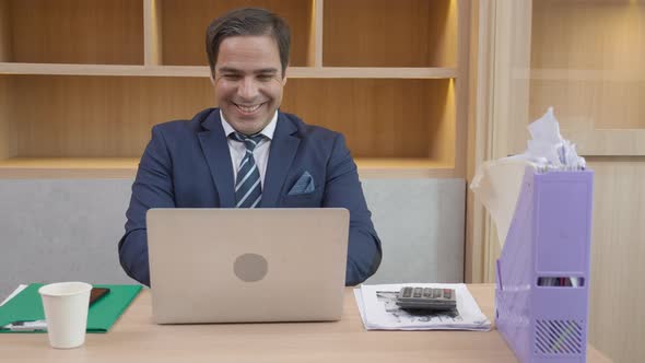 Happiness young business man using laptop computer planning for success in modern office.