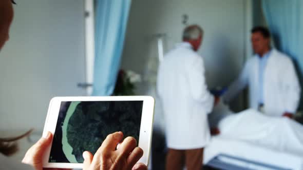 Doctor examining report on digital tablet