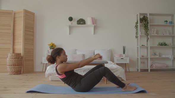 Determined Fitness Woman Doing Sit-ups at Home