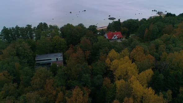 Aerial view of a house in the middle of a forest during the autumn, Estonia.