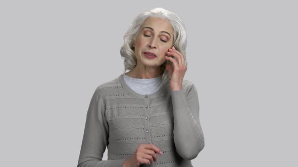 Old Lady Accepting Phone Call and Talking