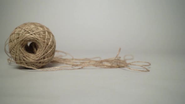 Moving and leaning skein with a natural grey background.