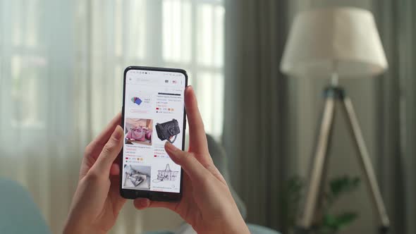 Close Up Of Hand Woman Lying On Couch Using Smartphone Buys In Internet Shop