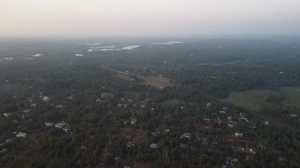 Extreme Long Shot of Train Passing Through Village, River, Kerala 4k