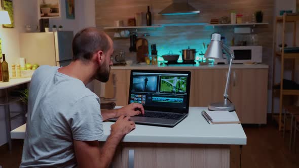 Content Creator Working on Laptop During Night Time