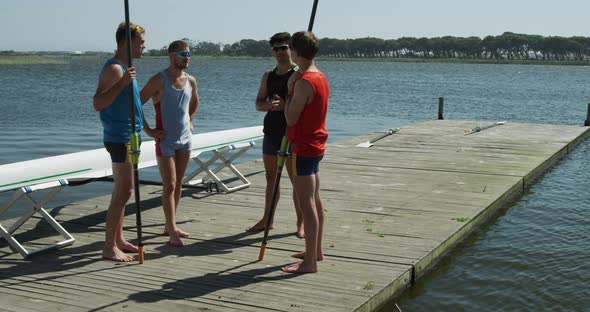 Side view of male rower discussing on the jetty