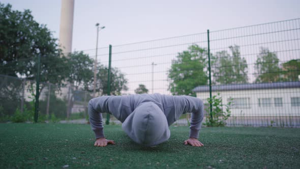 Man doing pushups. Evening workout in an outdoor gym. Health and fitness